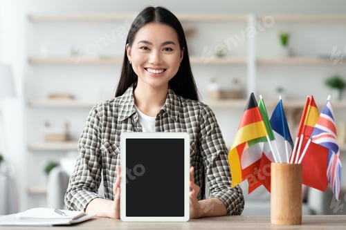 Preview: Happy asian woman showing digital tablet with blank screen