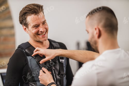 Preview: Fitness Instructor Putting An Ems Suit To A Man