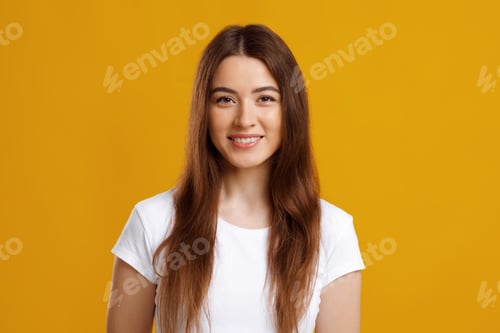 Preview: Attractive young woman posing on colorful studio background
