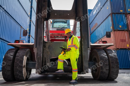Preview: Male Container yard worker control and checking container.