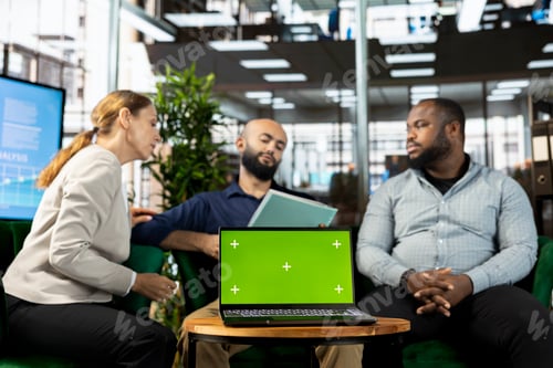 Preview: Diverse team of office clerks checking accounting figures in paperwork
