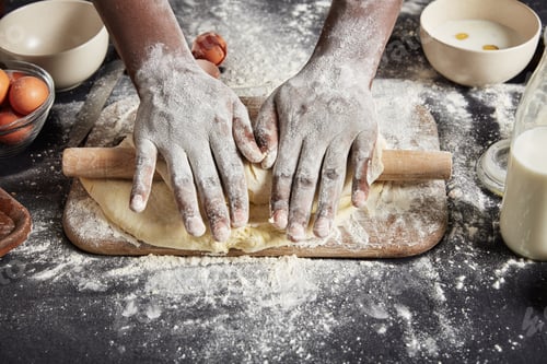 Preview: Top view of man`s hands rolls up dough with rolling pin, makes it very thin, bakes delicious pizza,