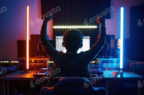 Preview: View from back on male music producer working in recording studio