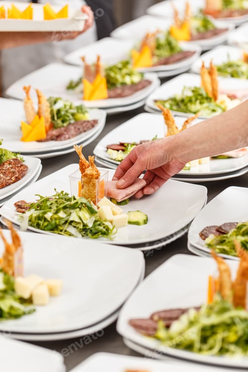 Preview: Cook is garnishing appetizer plates