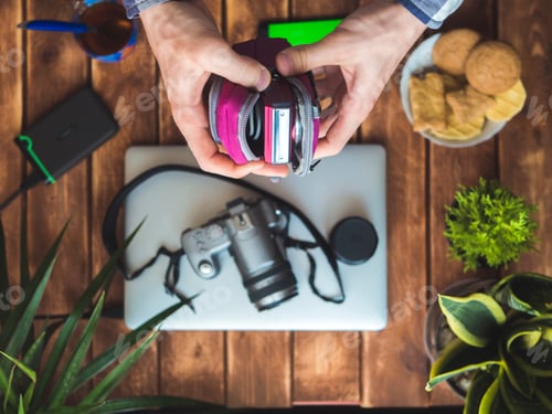 Preview: compact camera in protection case in hands