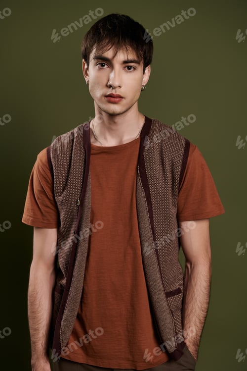 Preview: A Mans Enigmatic Gaze Against a Vibrant Green Backdrop