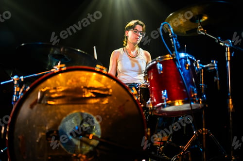 Preview: Drummer performing live on stage with drum kit