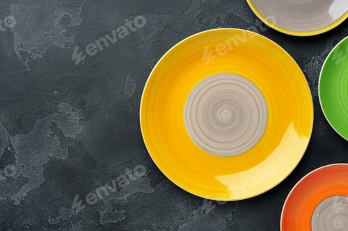 Preview: Color ceramic plates on gray background top view