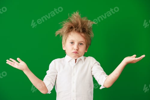 Preview: Surprised child against green chalkboard in class