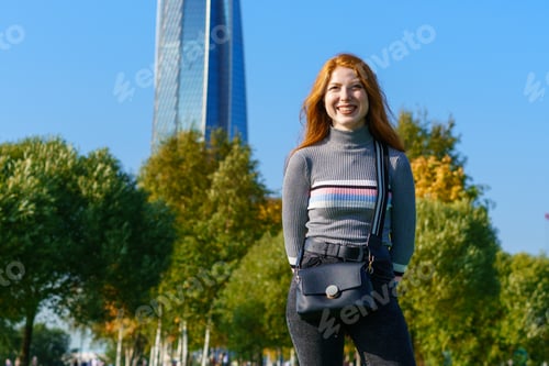 Preview: Redhead happy woman posing in the park on a sunny day