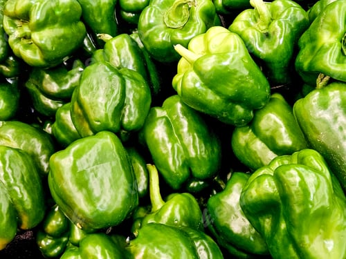 Preview: Overhead food flat lay green bell peppers as produce in grocery store.