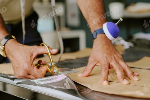 Preview: Male Hands Cutting Fabric on Table