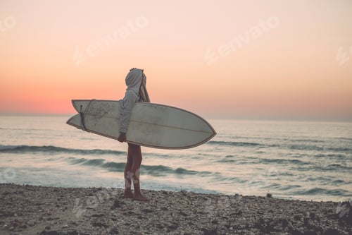 Preview: Surfer Walking on Beach at Sunrise with Surfboard