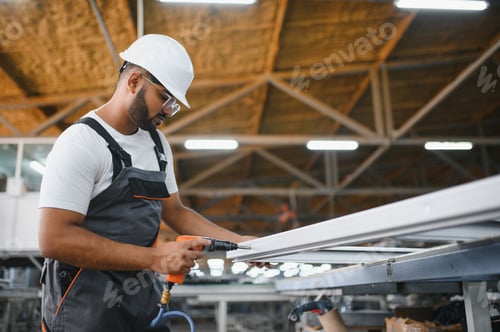 Preview: Young Indian male engineer wearing safety workwear standing in the factory