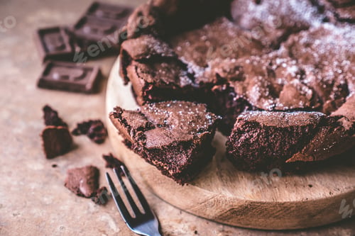 Preview: Close up of Chocolate cake on wooden tray with fork.