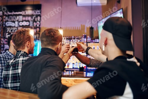 Preview: Group of people together indoors in the pub have fun at weekend time