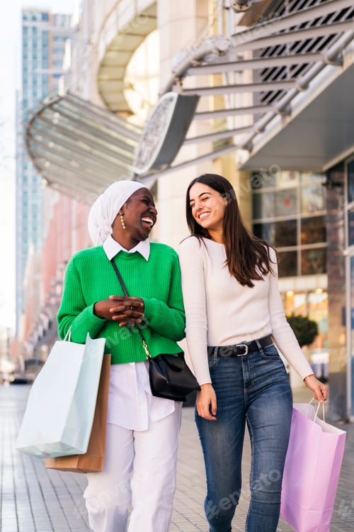 Preview: couple of female friends walking in shopping area