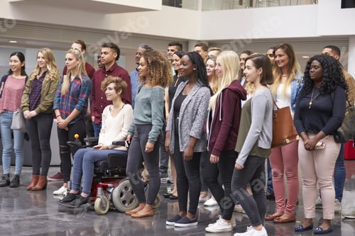 Preview: Student group standing in university atrium looking away