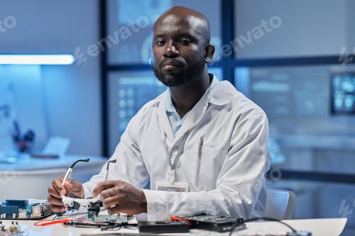 Preview: Engineer sitting at his workplace in the lab