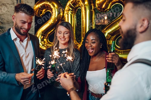 Preview: Happy group of friends celebrate New Year's Eve in a club