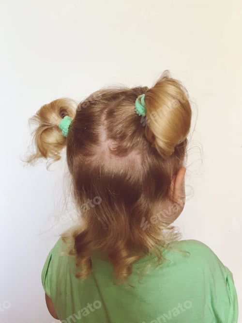 Preview: Blond Toddler with Pigtails Wearing Green Shirt