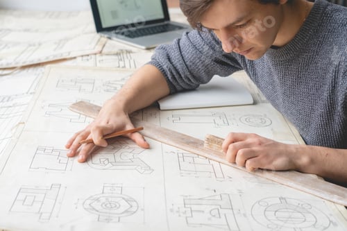 Preview: young architector working on his house plan b