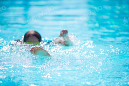 Preview: Happy little girl having fun in outdoor swimming pool