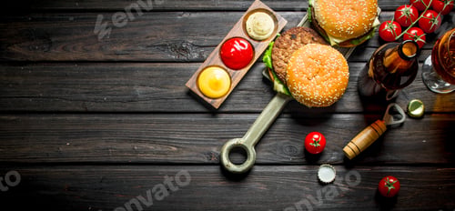 Preview: Burgers with beer in a bottle and a glass.