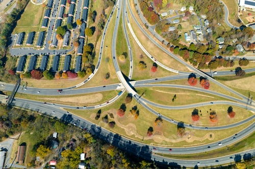 Preview: Aerial view of american freeway intersection with fast moving cars and trucks.