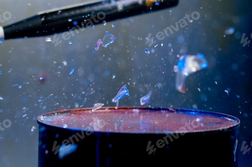 Preview: close up of a baseball bat smashing a glass in a destroy room for stress relief glass flies