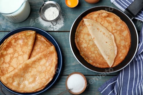 Preview: Flat lay composition with thin pancakes on blue wooden table