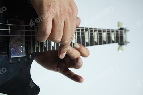 Preview: Closeup shot of a guitarist performing a complicated lick on an electric guitar