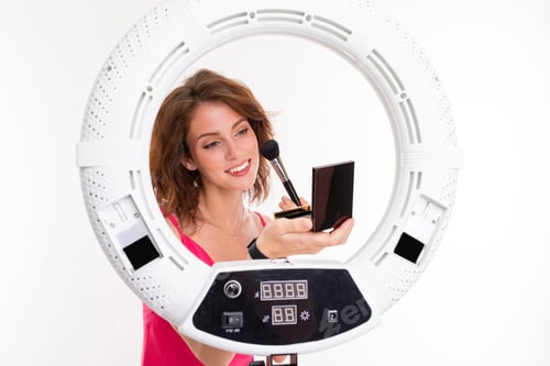 Preview: Woman Applying Makeup in Front of Ring Light