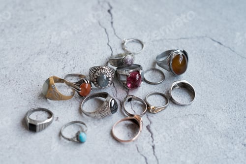 Preview: men rings collection on a concrete background