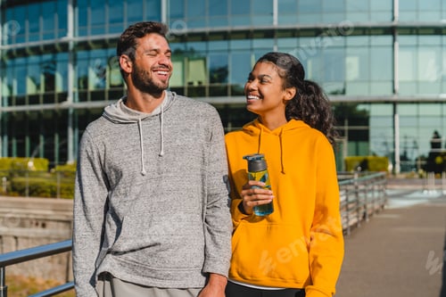 Preview: Beuatiful young couple of a caucasian boy and Latina girl talking and walking after jogging together