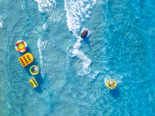 Preview: People having fun on the beach. Aerial view on fast boat on blue sea at sunny day.