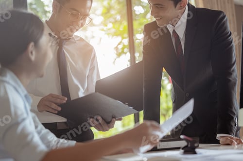 Preview: The business team working together happily at the office Business men are introducing