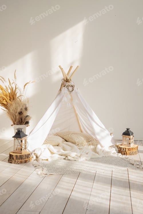 Preview: White fabric wigwam and Native American decor in a children's room on a sunny day.