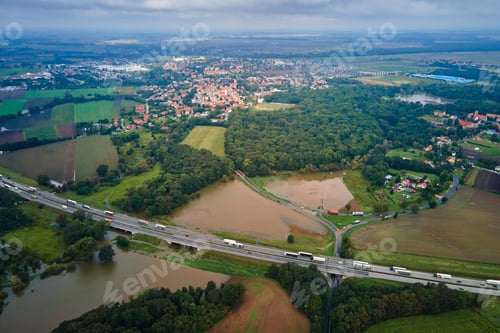 Preview: Flooded landscape with highway and rural town