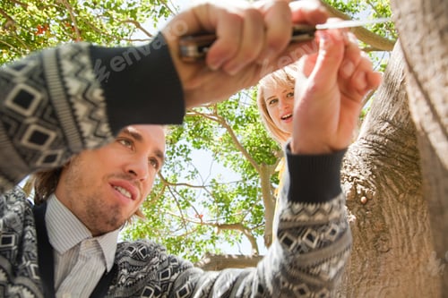 Preview: Couple carving names on tree