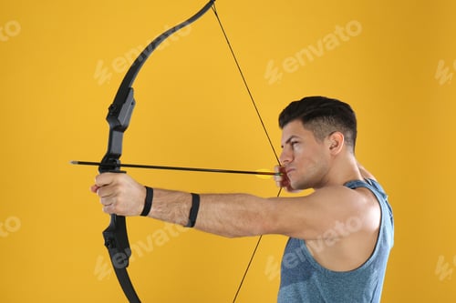 Preview: Man with bow and arrow practicing archery on yellow background