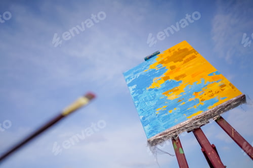 Preview: A close-up of oil painting standing on an easel against the sky the concept of love of fine art