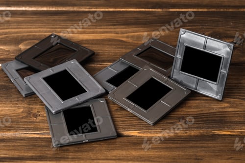 Preview: Photography empty slide frames on wooden background