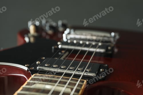Preview: Beautiful six - string electric guitar against dark background, closeup
