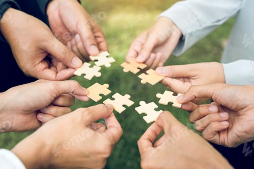 Preview: group of business people assembling jigsaw puzzle. The concept of cooperation, teamwork