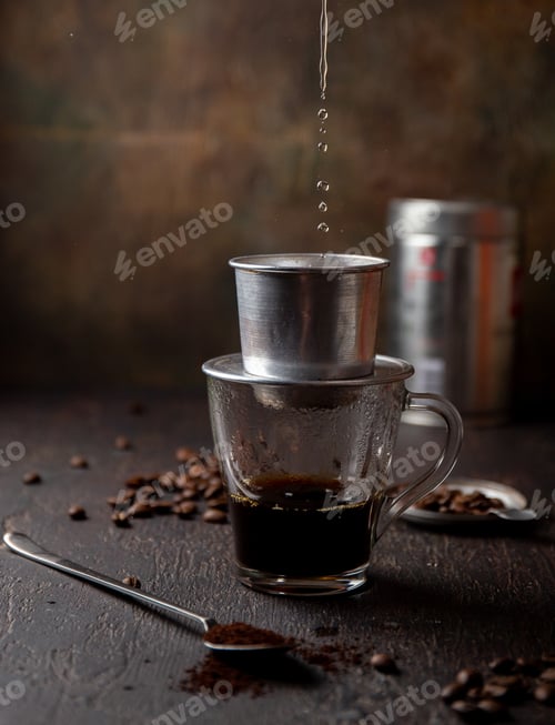 Preview: Preparation of Vietnamese coffe with vietnamese coffe filer on dark background