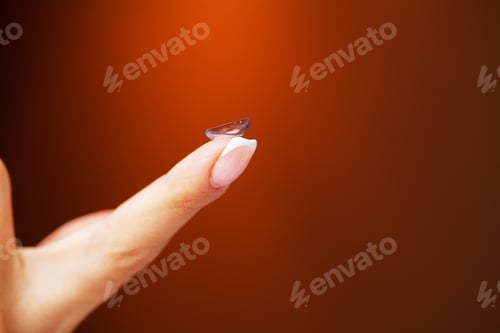 Preview: Woman holding a contact lens for eye on her finger