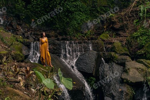 Preview: Relaxed international woman standing on big stone