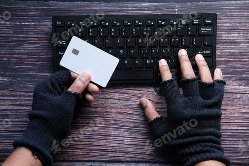Preview: hacker hand stealing data from credit card