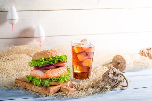 Preview: Closeup of big fishburger with salmon on fishing net